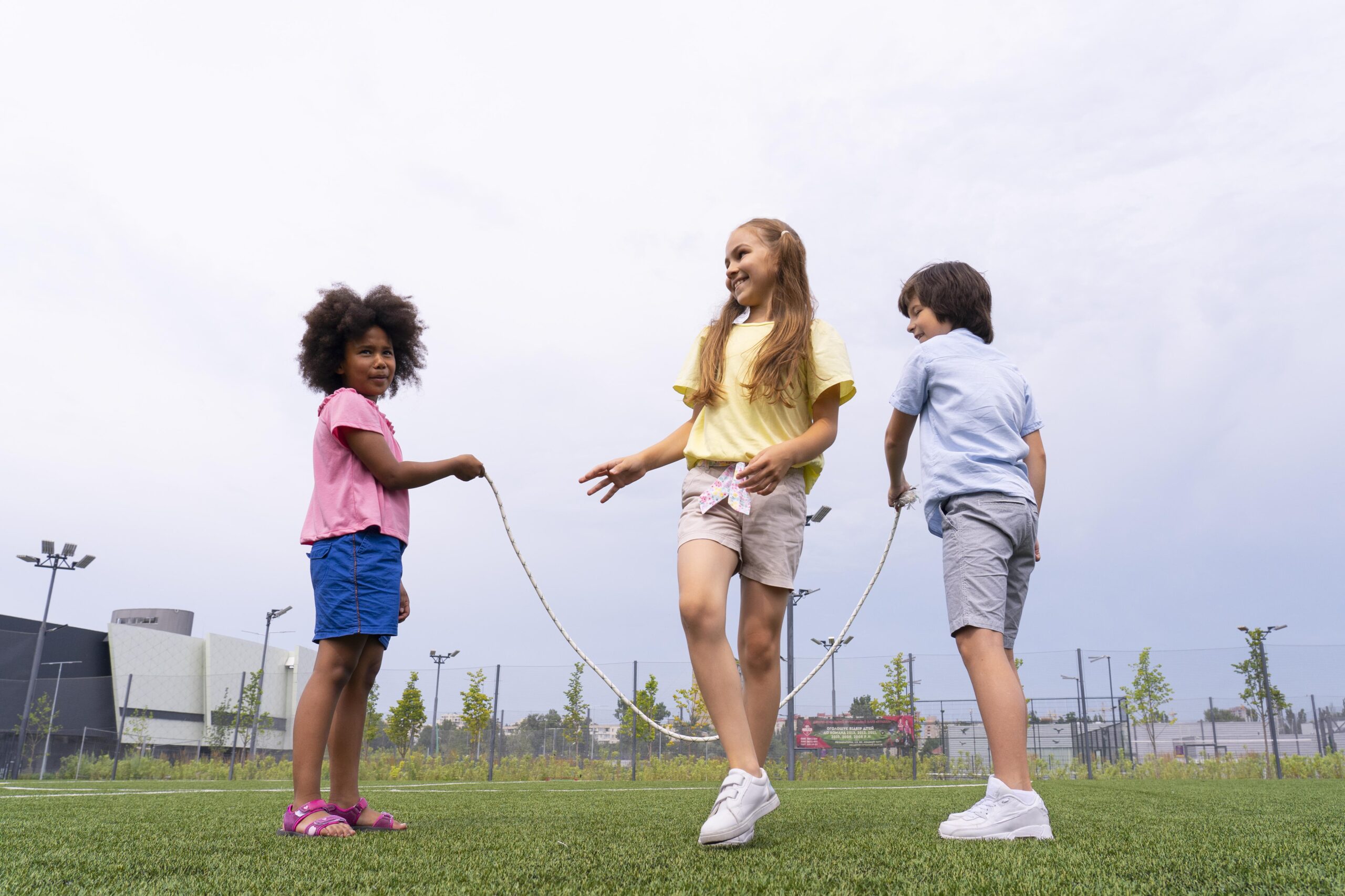 full-shot-smiley-girl-jumping-rope